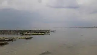 Jersey thunderstorm on rising tide in Grouville Bay