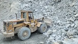 Caterpillar 966D Working at Mining Site: Loading and Transporting Big Rocks