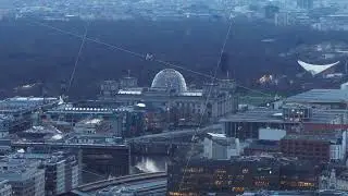 Aerial view of Berlin's Reichstag Palace, the site of the Bundestag, at dusk, showcasing iconic