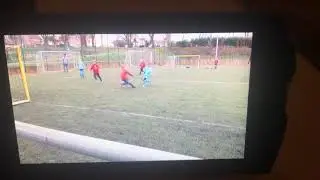 A 6 year old boy playing soccer / football