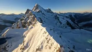 AERIAL POV DRONE FLYING OVER SNOW-CAPPED MOUNTAINS | FREE TO USE