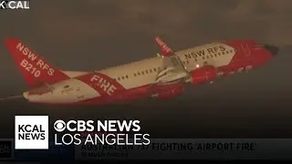 Firefighting plane on loan from Australia seen dropping water on Airport Fire in Orange County