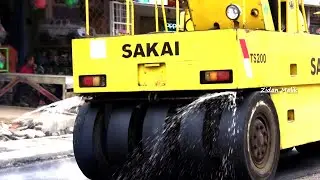 Tire roller process for compacting and leveling asphalt by SAKAI TS200
