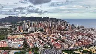 Urban Mountain View, Drone Captures Moody Urban Landscape With Textured Rooftops And Surroundings