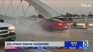 Spectators scale 6th Street bridge to watch cars drift, do burnouts