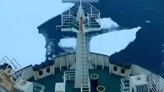 Cargo ship. Crossing the ice in the winter periud. Marine logistics.