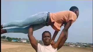 Strong and fit African girl overhead lift and carry | also carry 4 boy and girls at once.