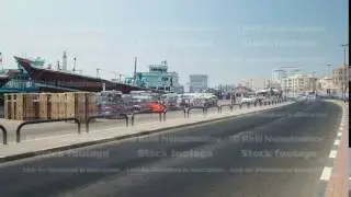 Boats at Port Saeed along Deira's shore of Dubai Creek, UAE. Timelapse view from road