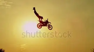 stock footage slow motion silhouette pro motocross rider riding fmx motorbike jumping big air kicker