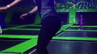 Slow motion back somersault on trampoline