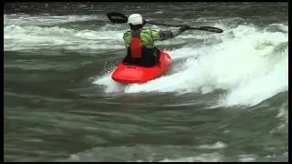 Jackson Kayak Rockstar Grinding a Small Wave