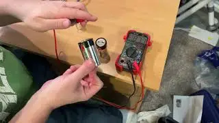 Alkaline battery with negative voltage