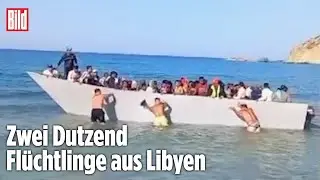 Fl&uuml;chtlinge erreichen Strand in Griechenland: Badeg&auml;ste schieben Boot wieder zur&uuml;ck