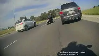 3-wheeled scooter rider lane split in roundabout 