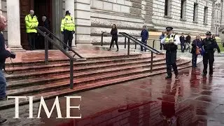 Climate Change Activists Spray Fake Blood Over U.K. Government Building | TIME