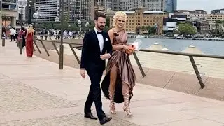 COURTNEY ACT RISKS A WARDROBE MALFUNCTION IN A SPLIT FRONT DRESS