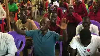 Worshipping God with praying and singing by CTC International of Gambella, Ethiopia.