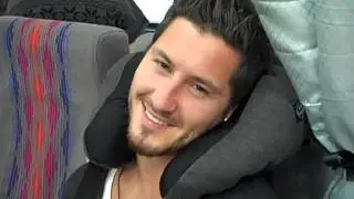 Val Chmerkkovskiy trying out the Comfy Commuter Travel Pillow. He looks pretty happy.