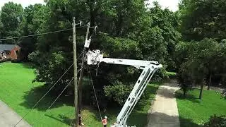 Workmen replacing power pole