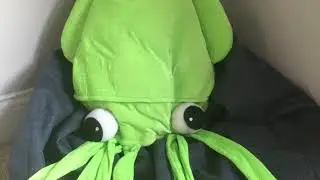 A picture of a derpy squid in a beanbag chair listening to elevator music