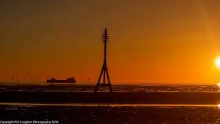 sunset over a merseyside beach uk