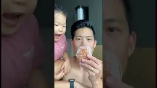 Kid steals the first bite of donut