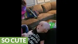 Baby has mind blown by sister's face paint