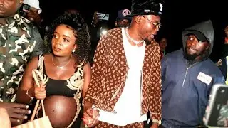 NADIA WALKS IN HOLDING THE MAN OF THE DAY ARROW BOY AT HIS ALBUM LAUNCH FOCUS