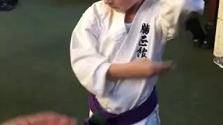 Jeremiah showing a Purple belt green tags technique