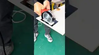 Cutting a wooden board with a handheld circular saw