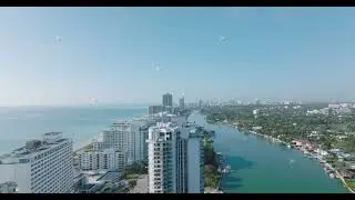 Luxury high rise buildings on Miami Beach. Aerial view of sea coast in town in tropical area. Miami
