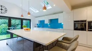 Handleless White Gloss Kitchen with Neff Appliances  and Marble Worktop.