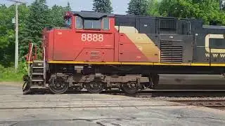 CN 8888, 8017 Eastbound train with centerbeam flat cars, box cars, tank cars, well cars, gondolas
