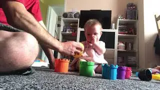 9 month old putting stacking cups inside each other