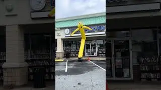 Wacky Arm Waving Inflatable Tube Man loves books