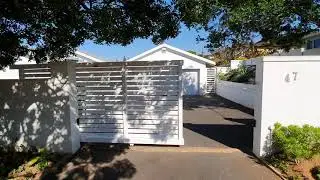 Value Fencing PVC Driveway entrance sliding gate in Horizontally slatted style, Dolphin Coast.
