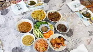 Lunch alms offering at the monastery with various types of homemade dishes.