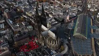 Aerial views capturing grandeur of Cologne Cathedral, bustling central train station, and expansive
