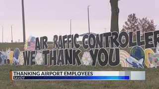 Group of pilots thanks ATC, TSA workers with sign in front of Willard