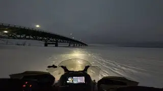 Arriving to Mackinac Bridge in Michigan on snowmobiles