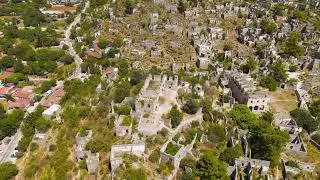 Kayakoy, Turkey. Aerial drone shot of ancient stone ruins in abandoned ghost town on rocky hill u...