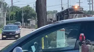 Gate Runner As 2 Norfolk Southern Trains Pass On CSX Tracks, 3 Ambulances Cross Railroad Crossing