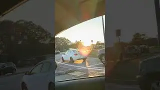 Moon is on left. Sun is on right. Traffic Light in a car.
