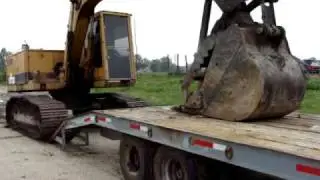 excavator loading on tag trailer