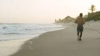 Man Jogging On The Beach