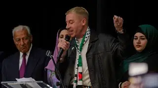Macklemore accepts the Rachel Corrie award at ArabCon 2024 in Dearborn, MI
