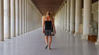 4K Following a tourist walk down a long hallway of greek columns at Stoa of Attalos, Athens Greece