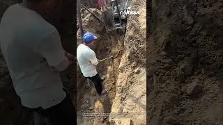 Teamwork & precision:  installing a large concrete pipe