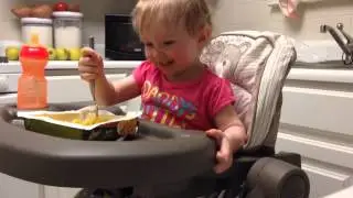 Baby eats macaroni and cheese