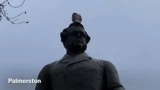 Parliament Square with statues of famous people & a pigeon - London